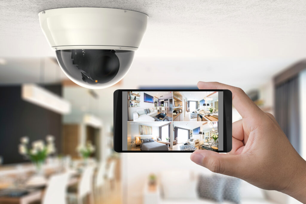Hand Holding 3D Rendering Mobile Connect with Security Camera
